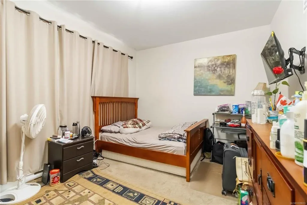 Bedroom with built-in storage, carpet, and natural light