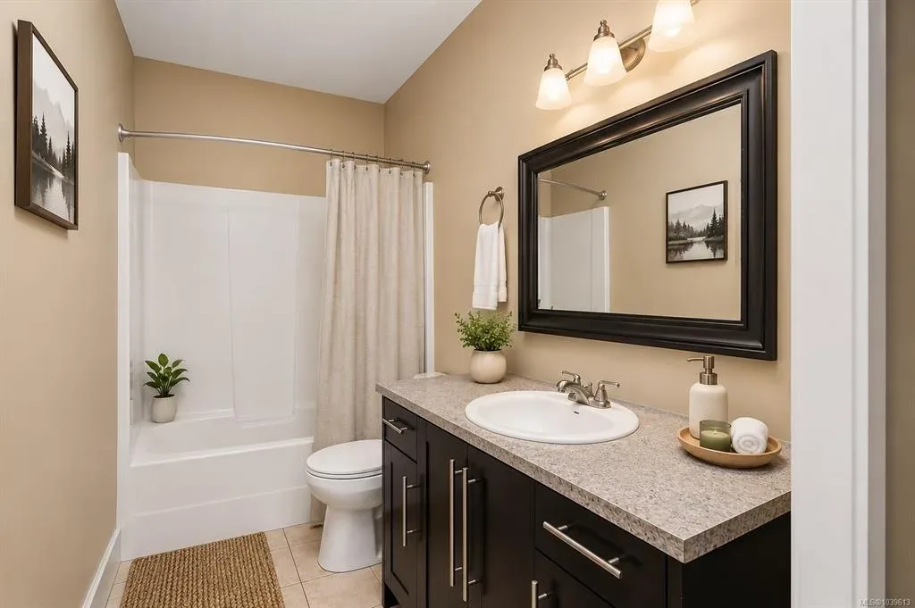 Additional bathroom with dark espresso vanity, tub-shower combo, and neutral tile