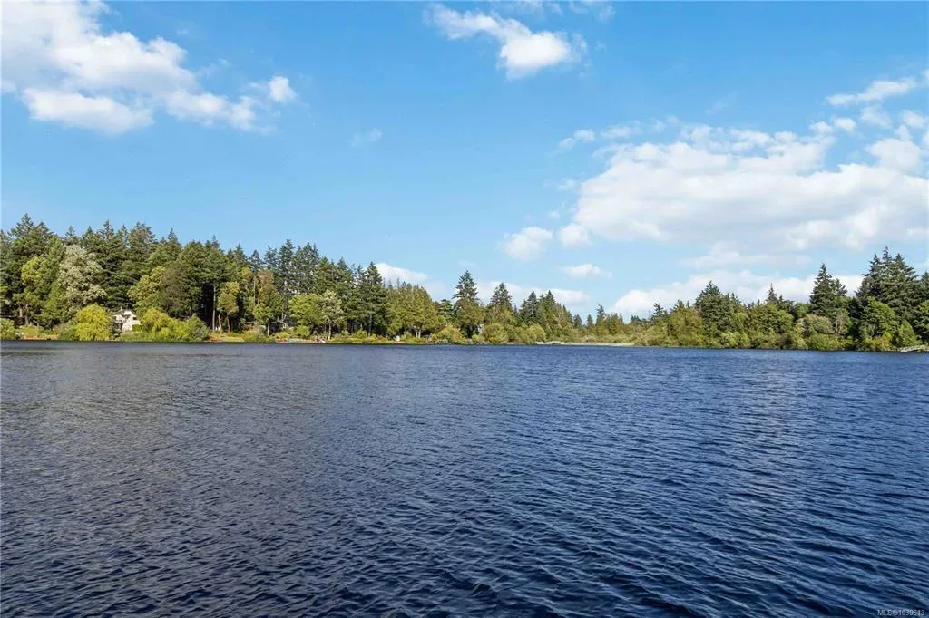 Scenic view of Glen Lake with calm blue water and dense evergreen forest surround
