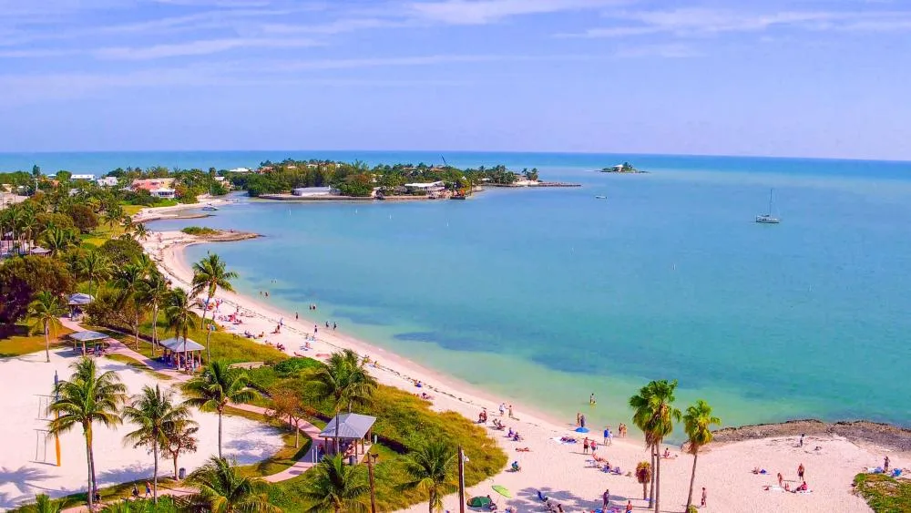 Aerial view of Sombrero Beach in Marathon, Florida Keys with white sand, turquoise water, and palm trees