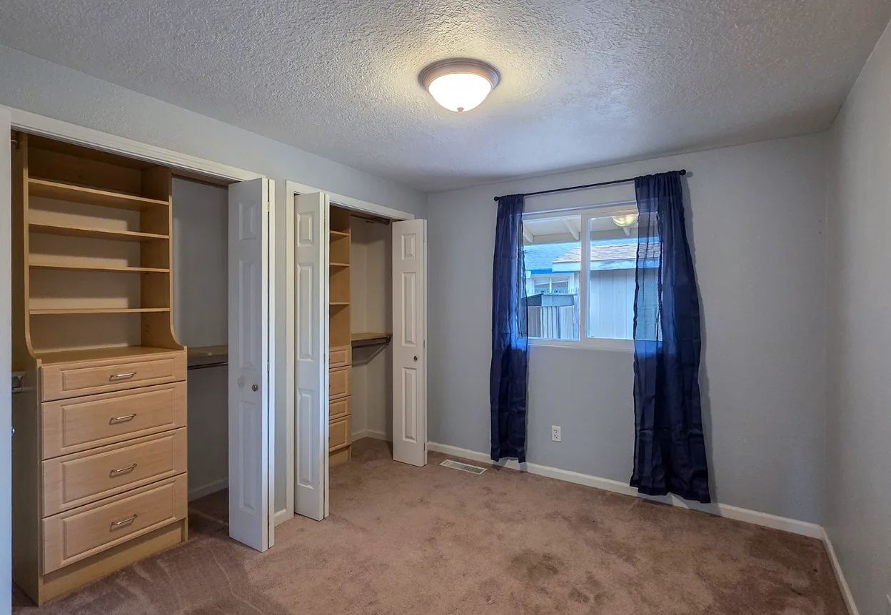 Bedroom with custom built-in shelving and drawers
