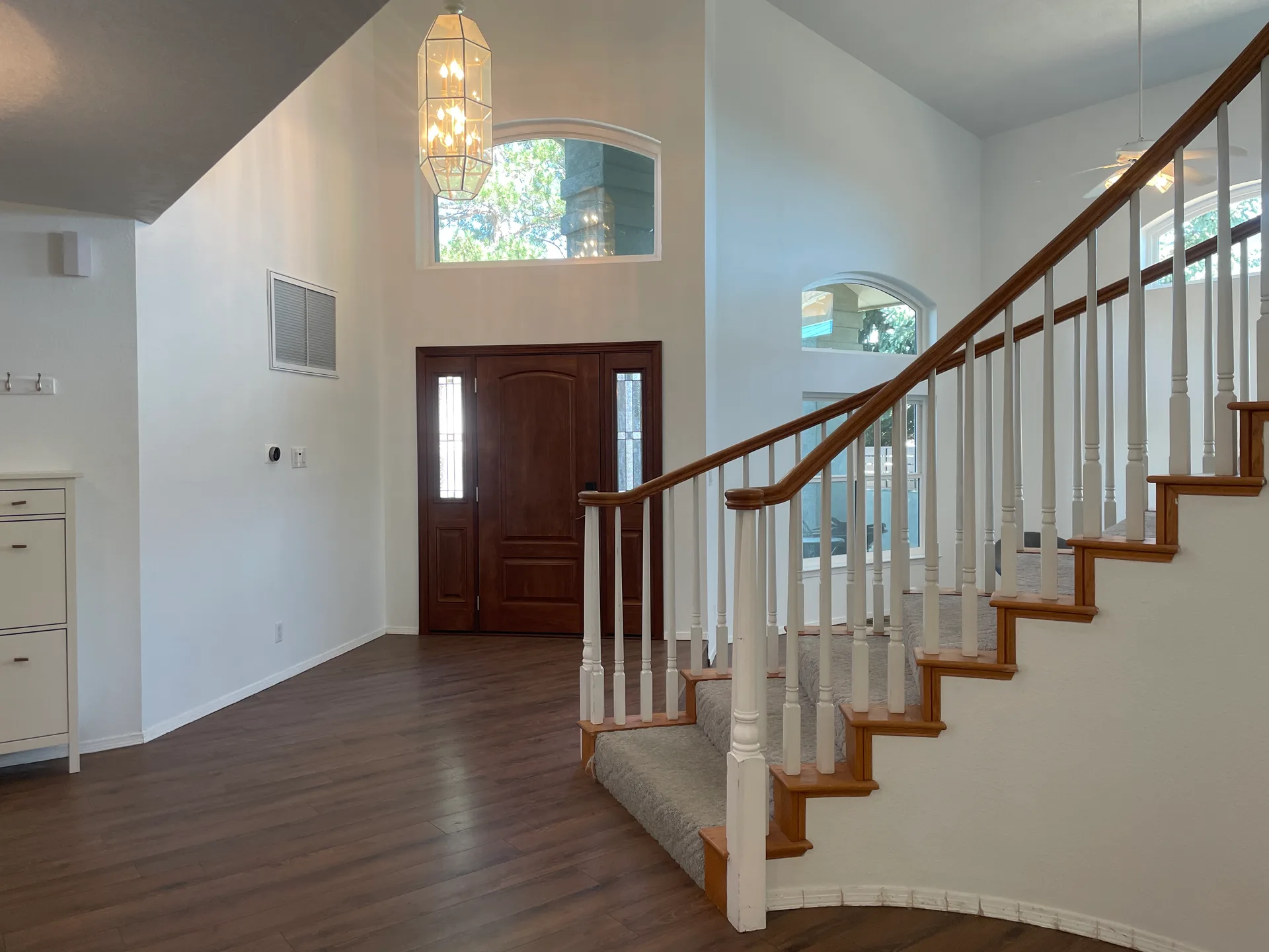 Two-story entryway with vaulted ceilings and a dark wood front door at 1506 Wells Dr NE