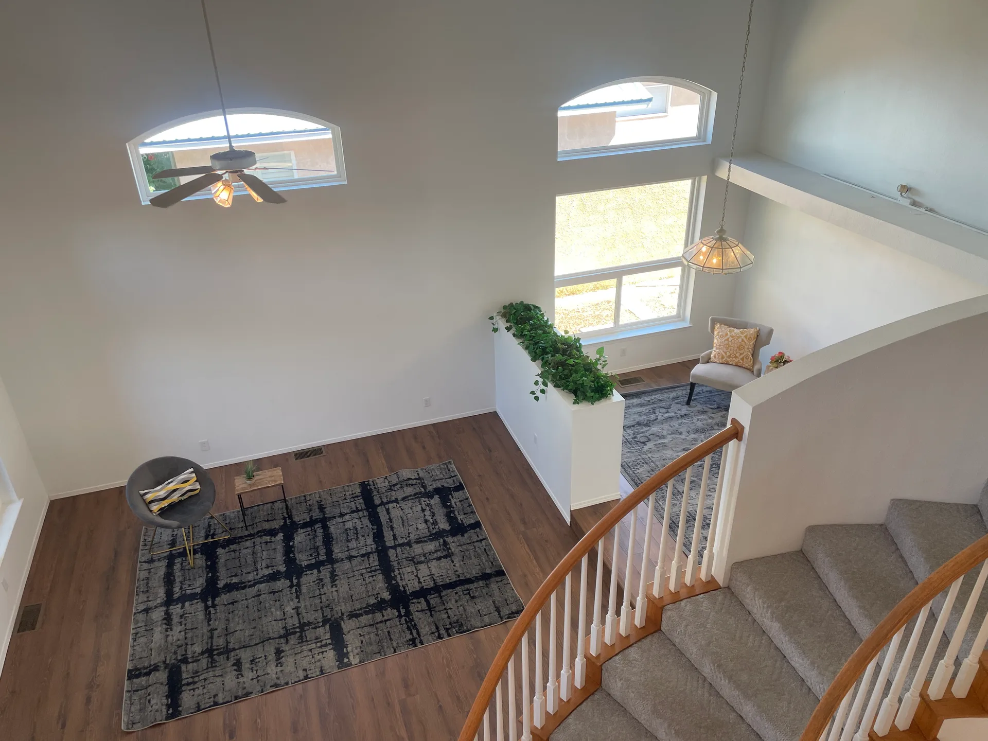 Elevated view into the living room and seating area with vaulted ceilings and open-concept layout