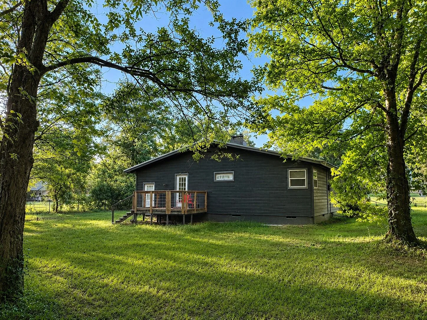 Peaceful backyard deck with tree-shaded lot