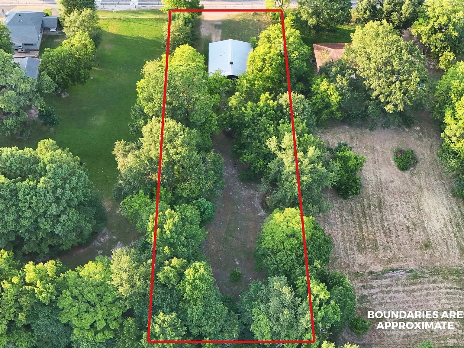 Drone aerial view of a wooded property lot in Omaha Texas