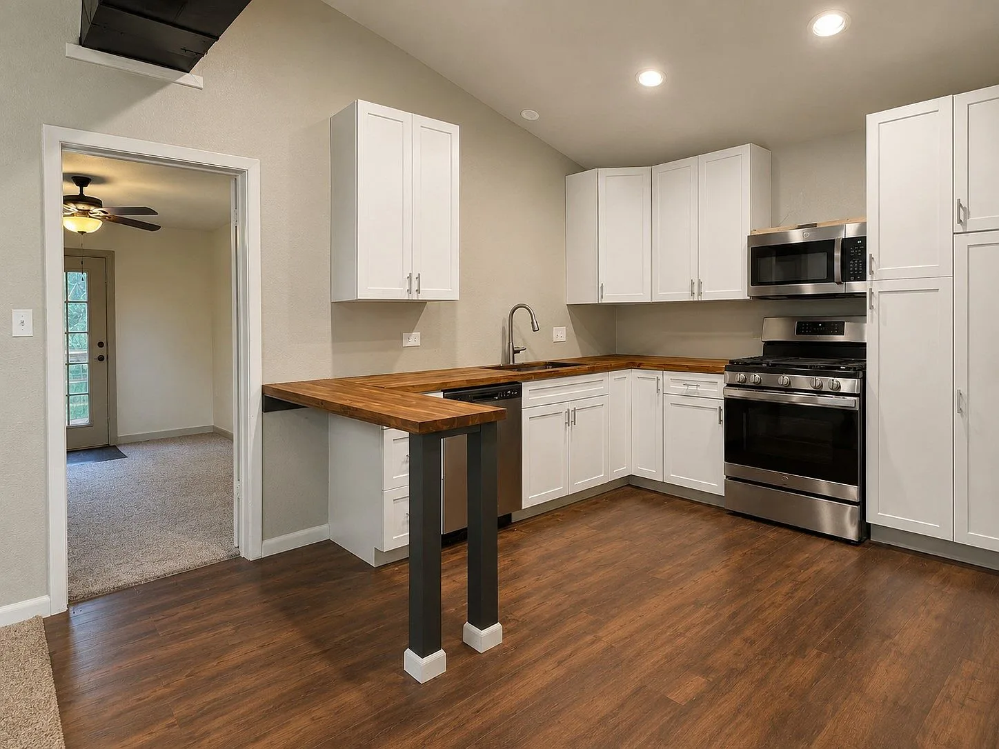 Kitchen with butcher-block countertops and stainless appliances