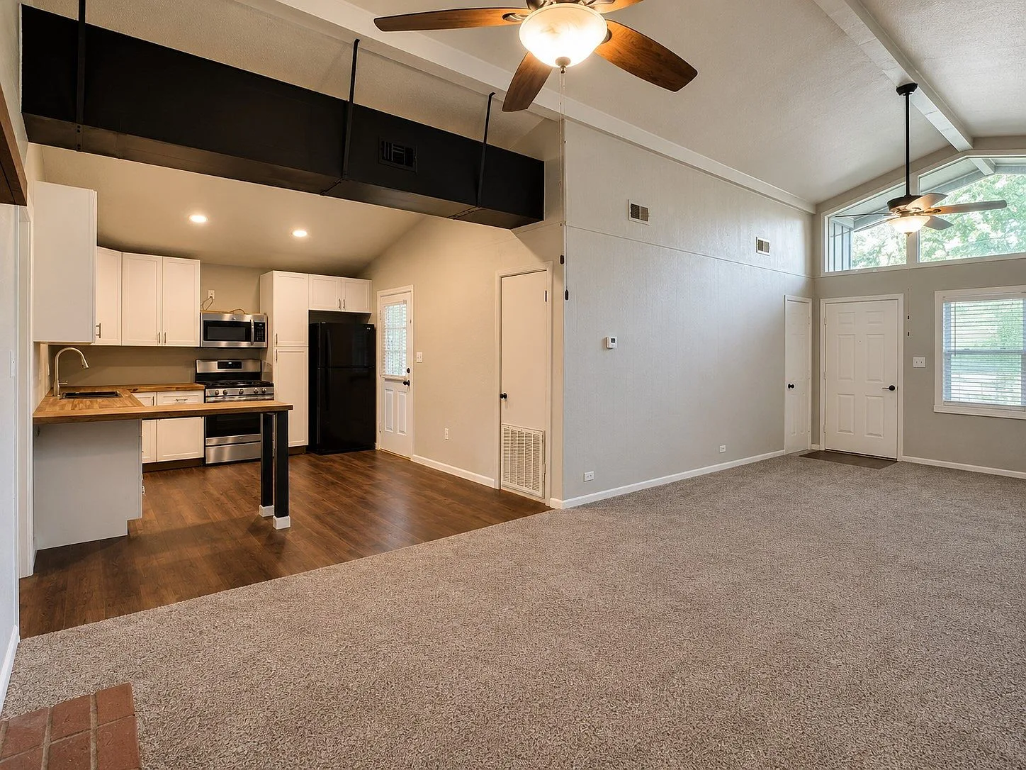 Open concept living room transitioning to kitchen