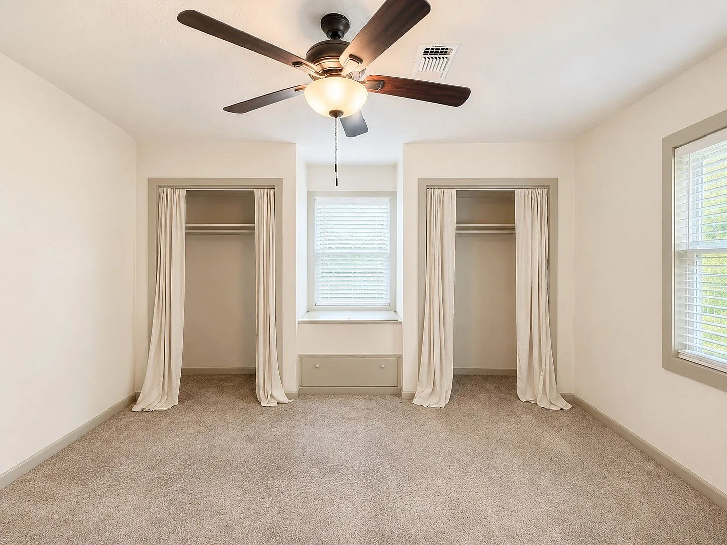Secondary bedroom with dual closets