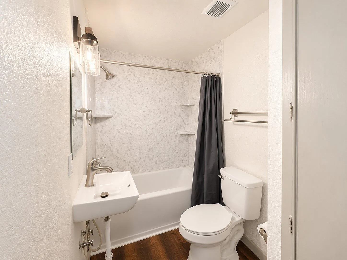 Modern bathroom with tub and marbled surround
