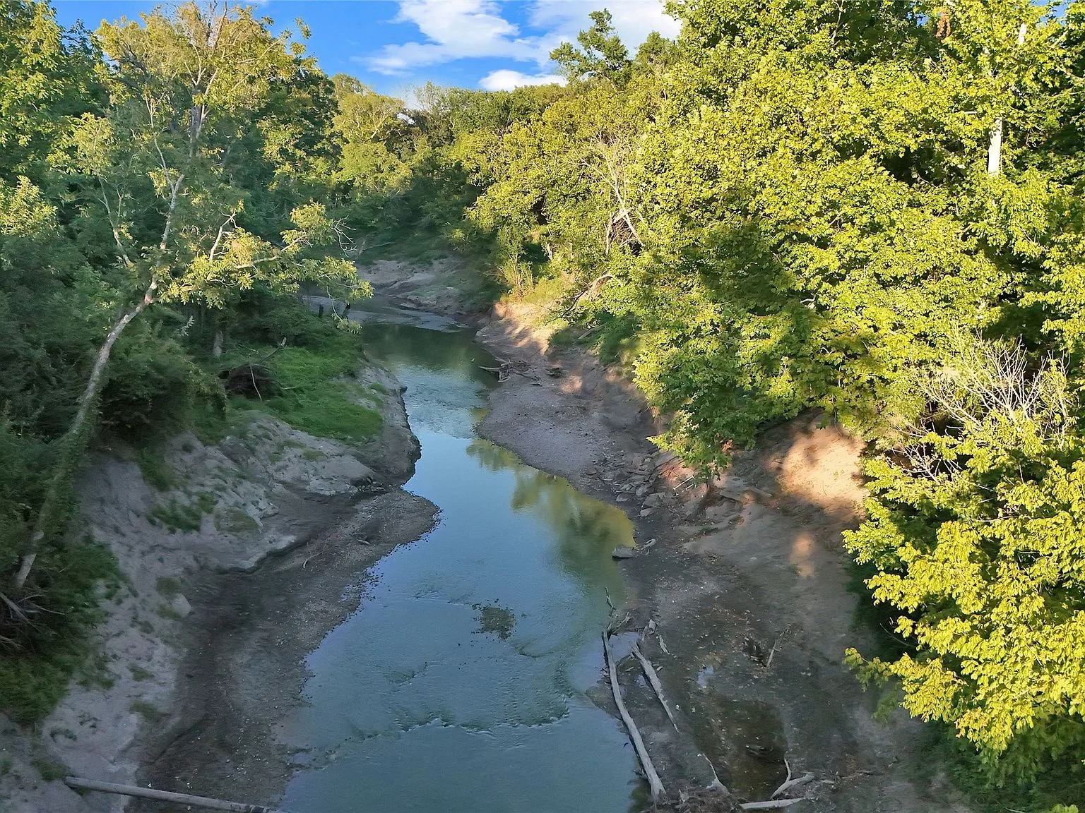 Sulphur River access with sandy banks and dense forest