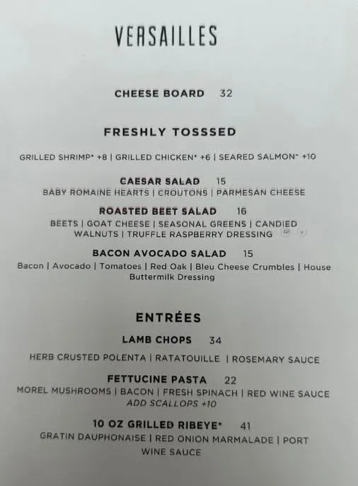 Versailles restaurant printed menu on display at Chateau Elan resort showing appetizers, salads, and entrees