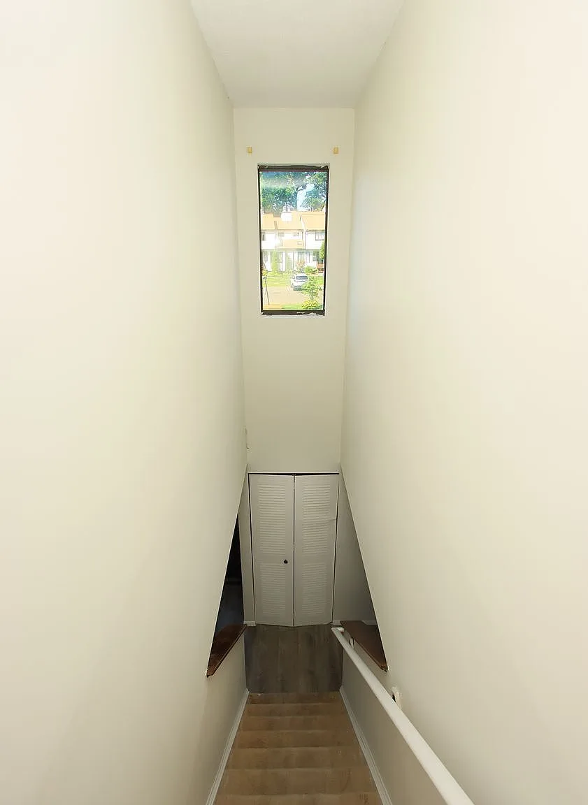 Interior stairwell with tall window and natural daylight