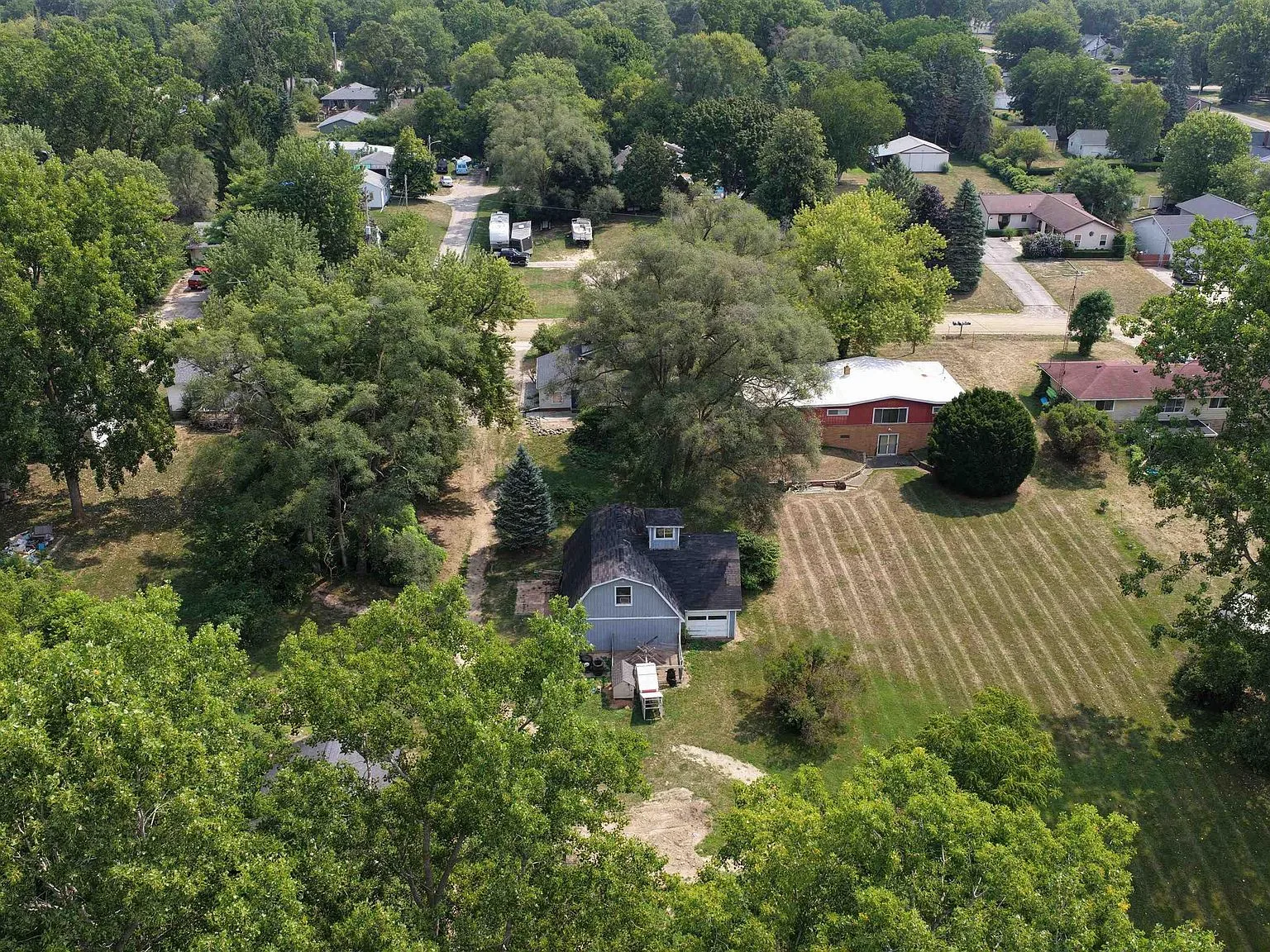 Drone view of the wooded lot and surrounding neighborhood