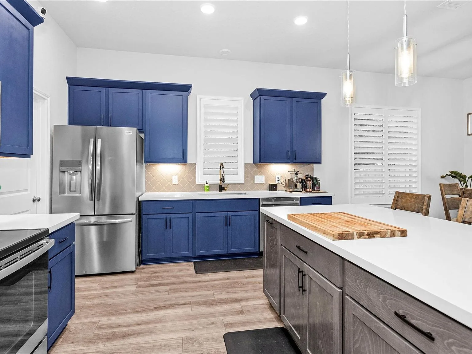 Kitchen with blue cabinetry and island