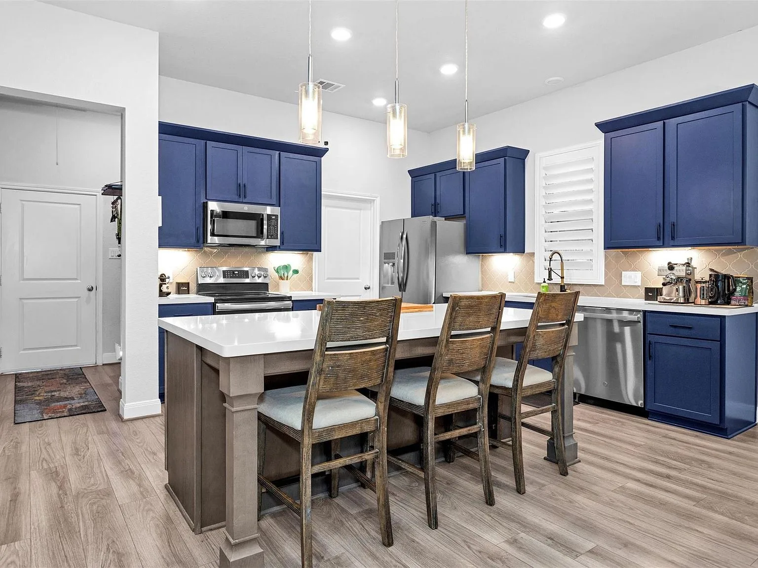 Modern kitchen with blue cabinets and pendant lights