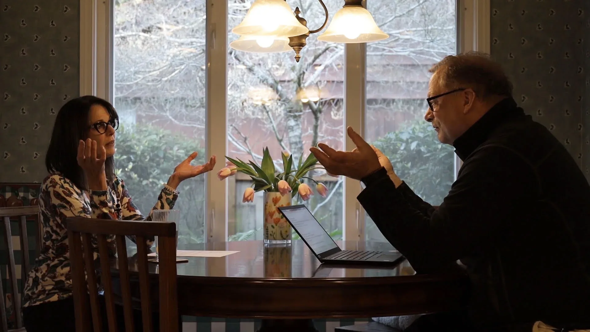 Sharon Glatz Scott in a consultation with a client at a dining table, reviewing details together