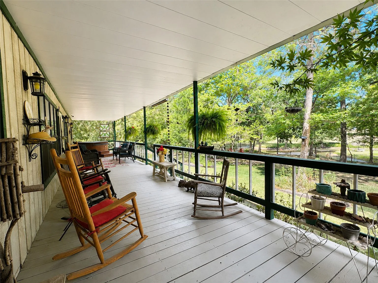 Spacious covered wrap-around porch with rustic farmhouse details