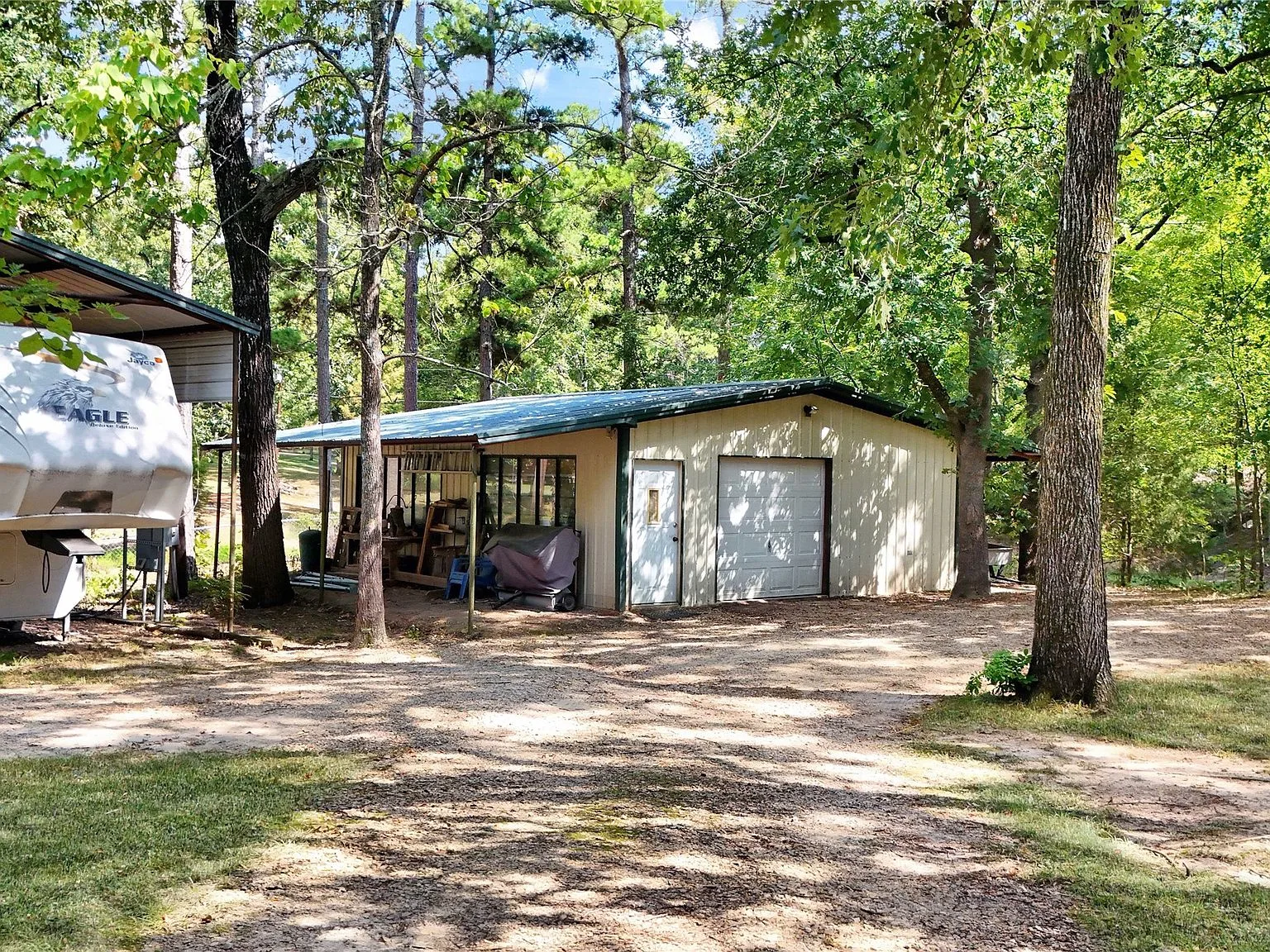Metal workshop outbuilding with covered storage
