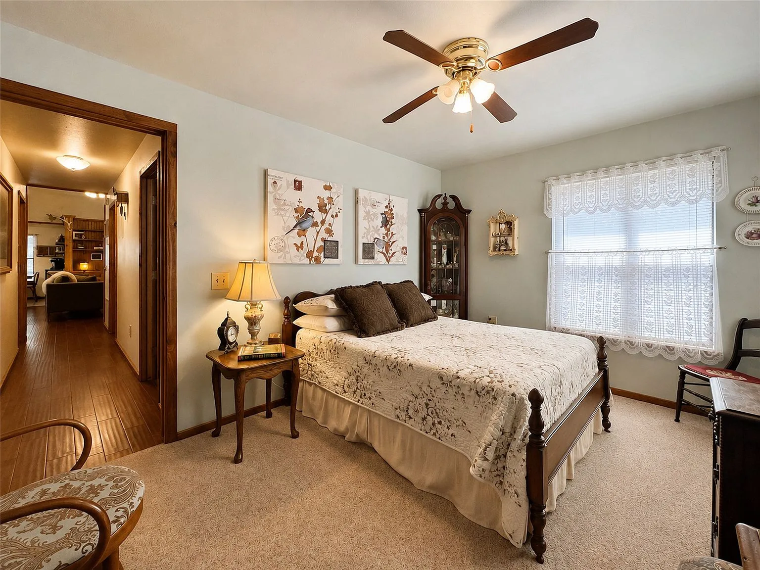 Primary bedroom with light blue walls and warm interior lighting