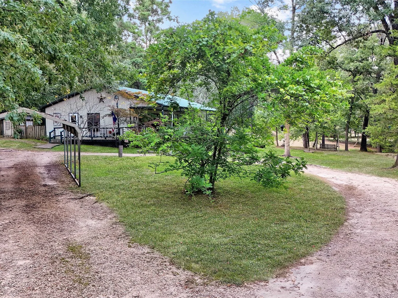 Angled exterior view of the ranch home and surrounding grounds