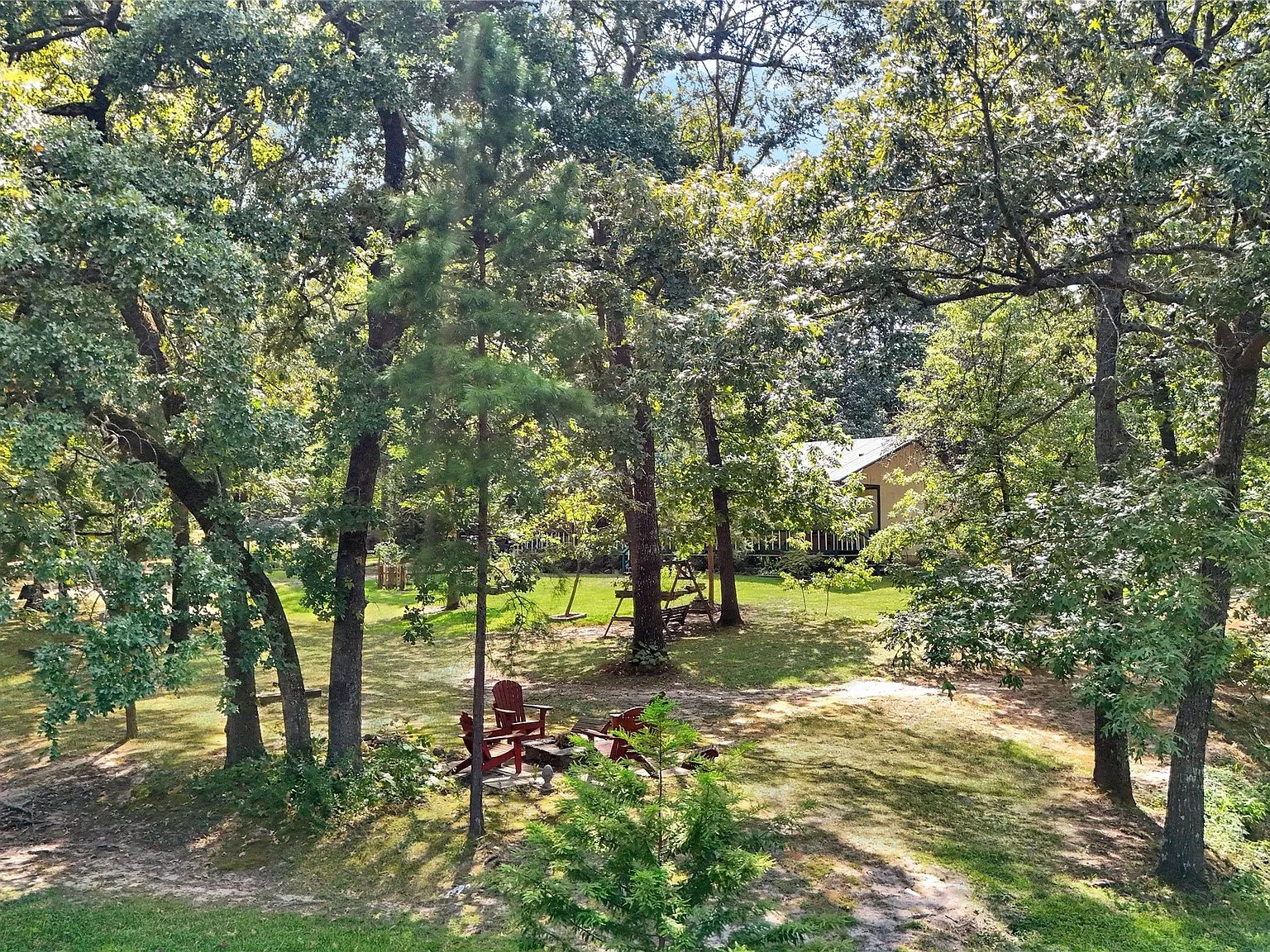 Spacious heavily wooded backyard with mature trees