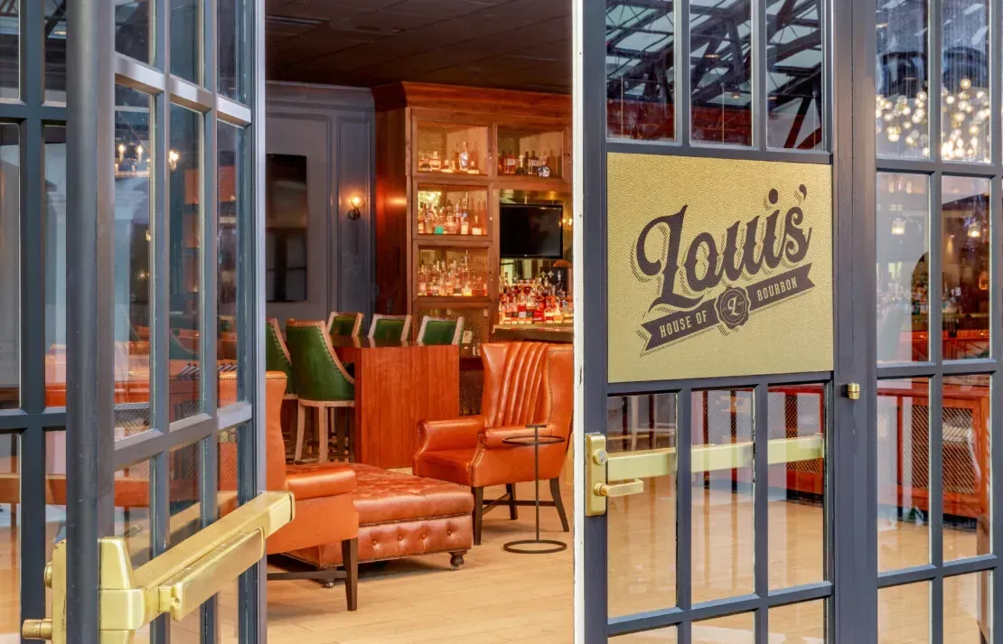 Cozy bar and lounge area visible through glass doors at Fleur de Lis spa restaurant Chateau Elan
