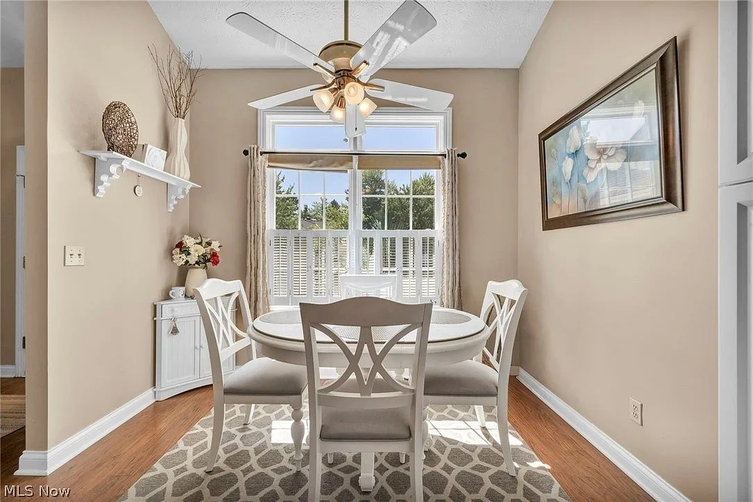 Kitchen dining nook with hardwood flooring and natural light