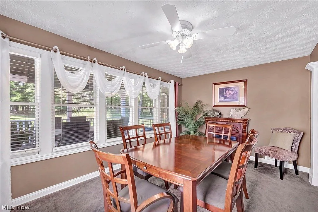 Bright sunroom with windows overlooking the covered deck
