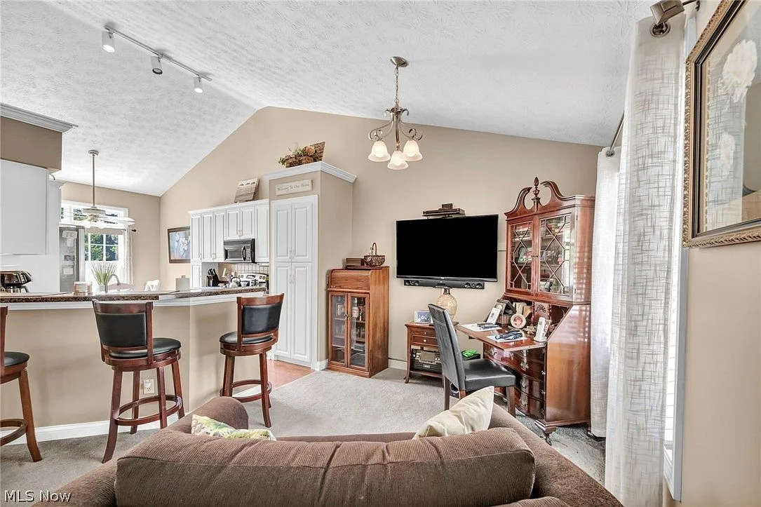 Living room with open view into kitchen