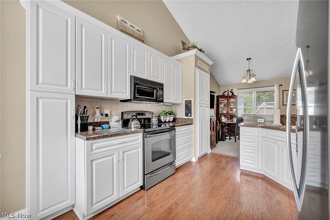 Wide kitchen view showing flow into dining area