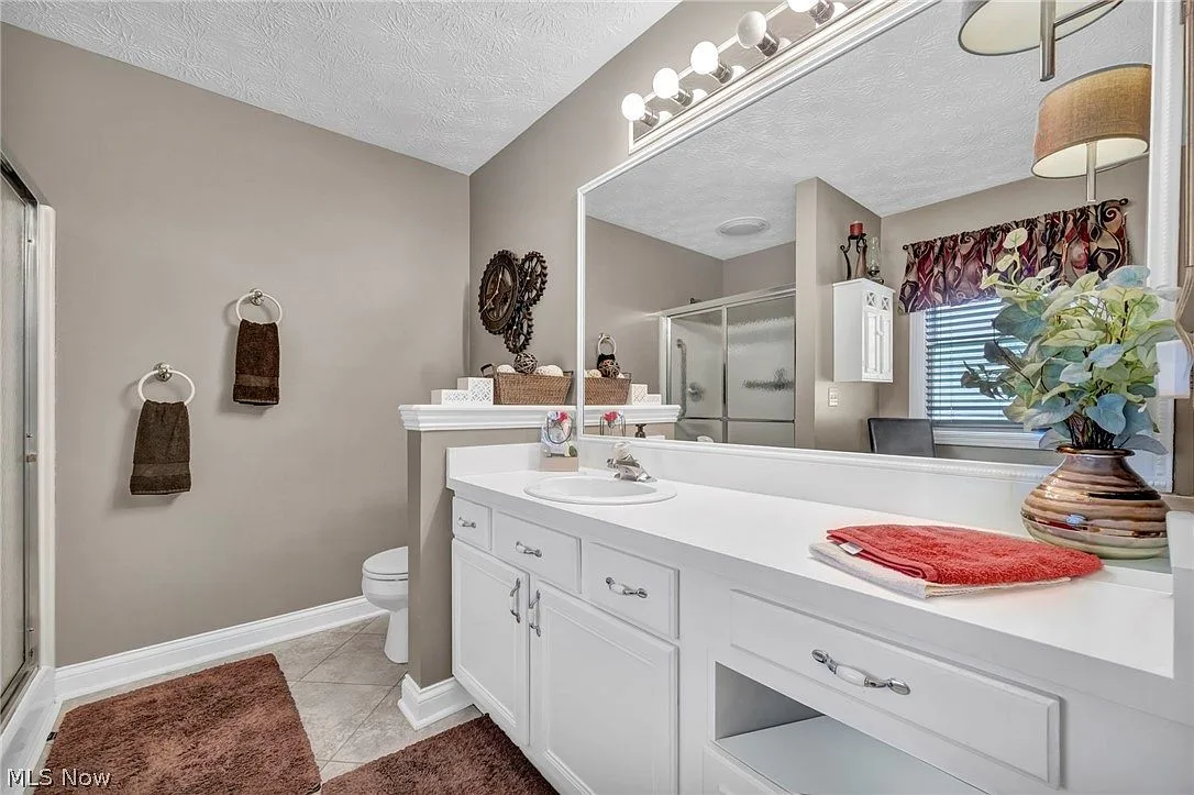 Master bathroom with large vanity and tile flooring