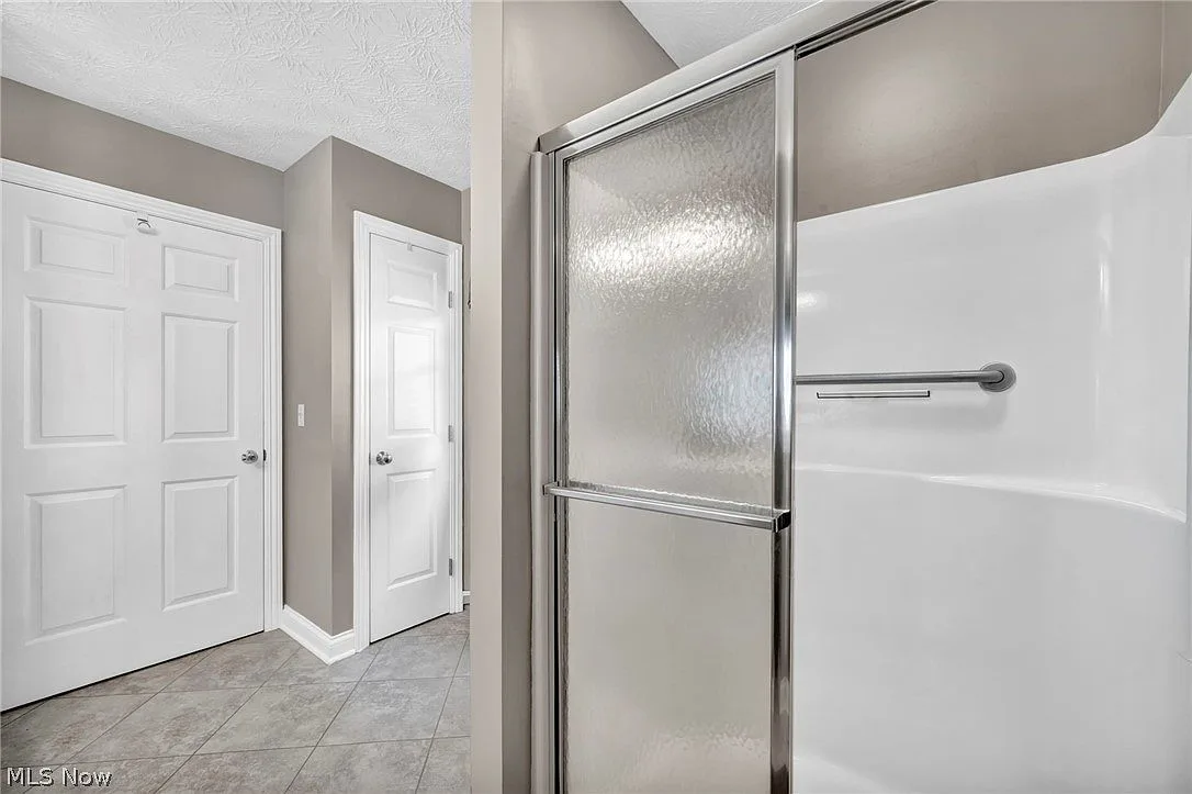 Bathroom shower stall with safety grab bar