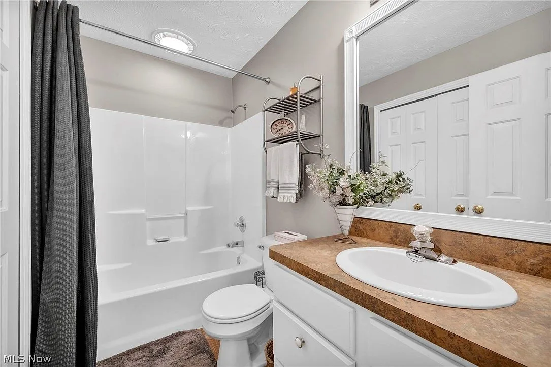 Full bathroom with vanity and shower