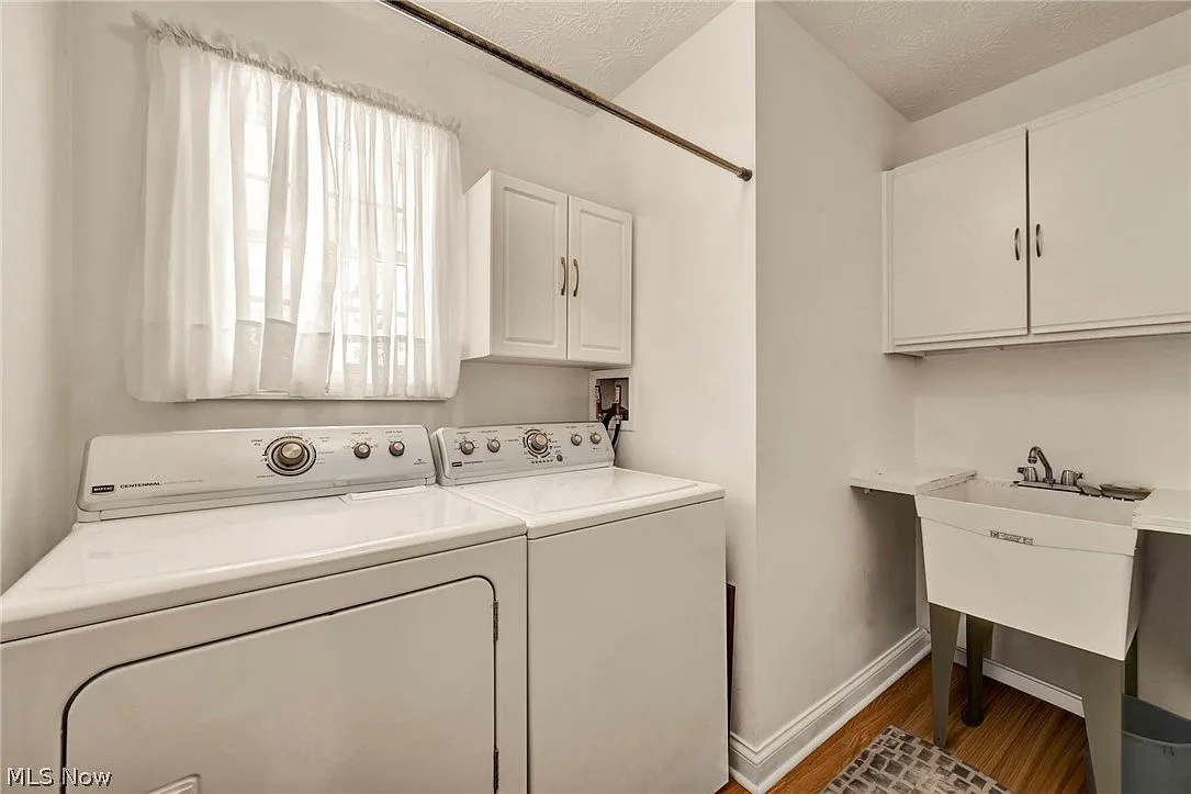 Laundry room with washer, dryer, and utility sink