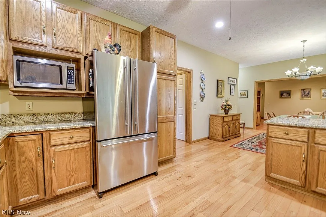 Wide-angle view of kitchen and adjacent dining area
