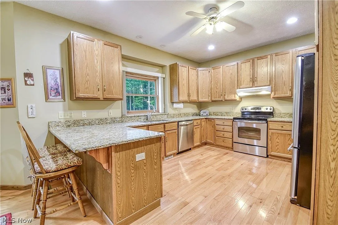 Kitchen with oak cabinetry and granite countertops