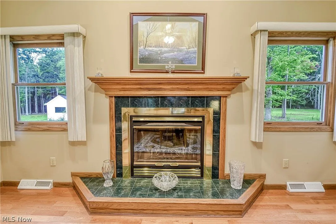Living room fireplace with tile hearth and wood mantle