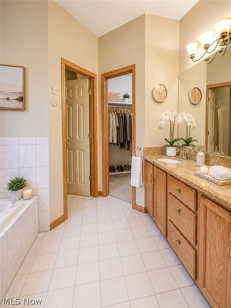 Primary bathroom with oak vanity and granite countertop