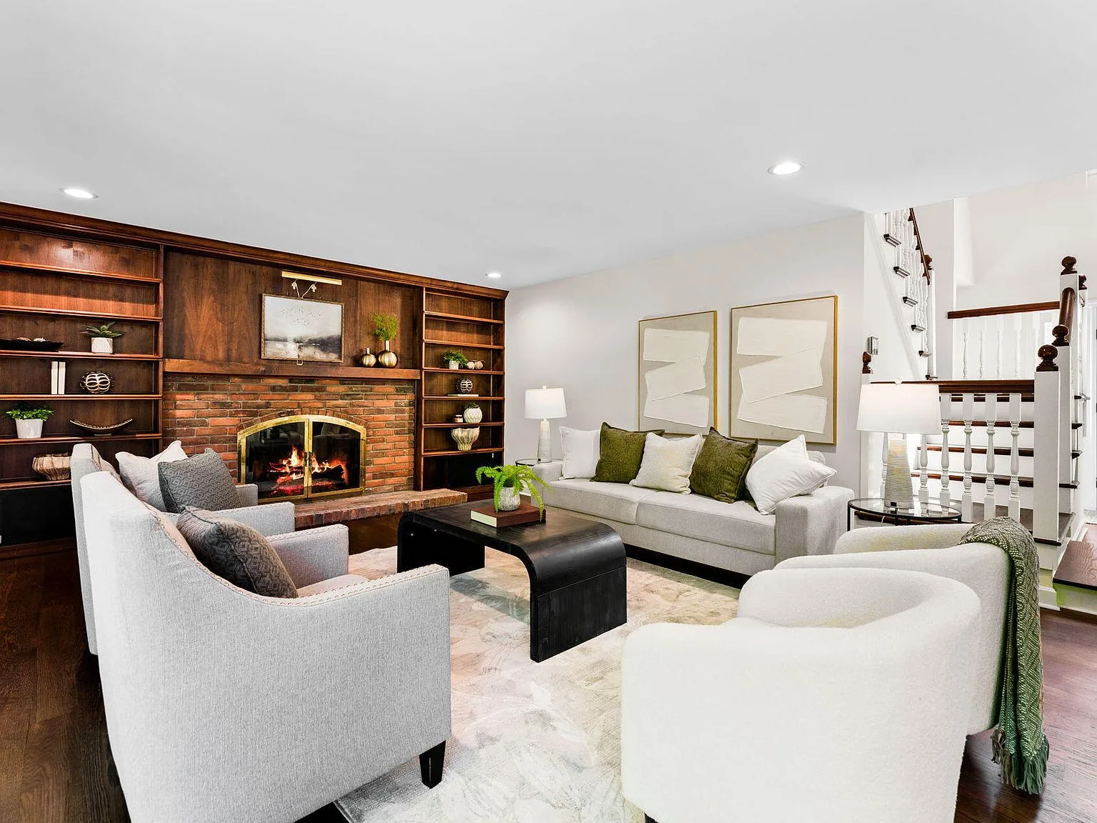 Family room with brick fireplace and built-in wood shelving