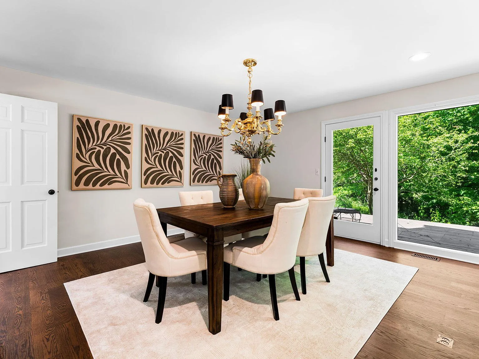 Formal dining room with dark wood floors and natural daylight