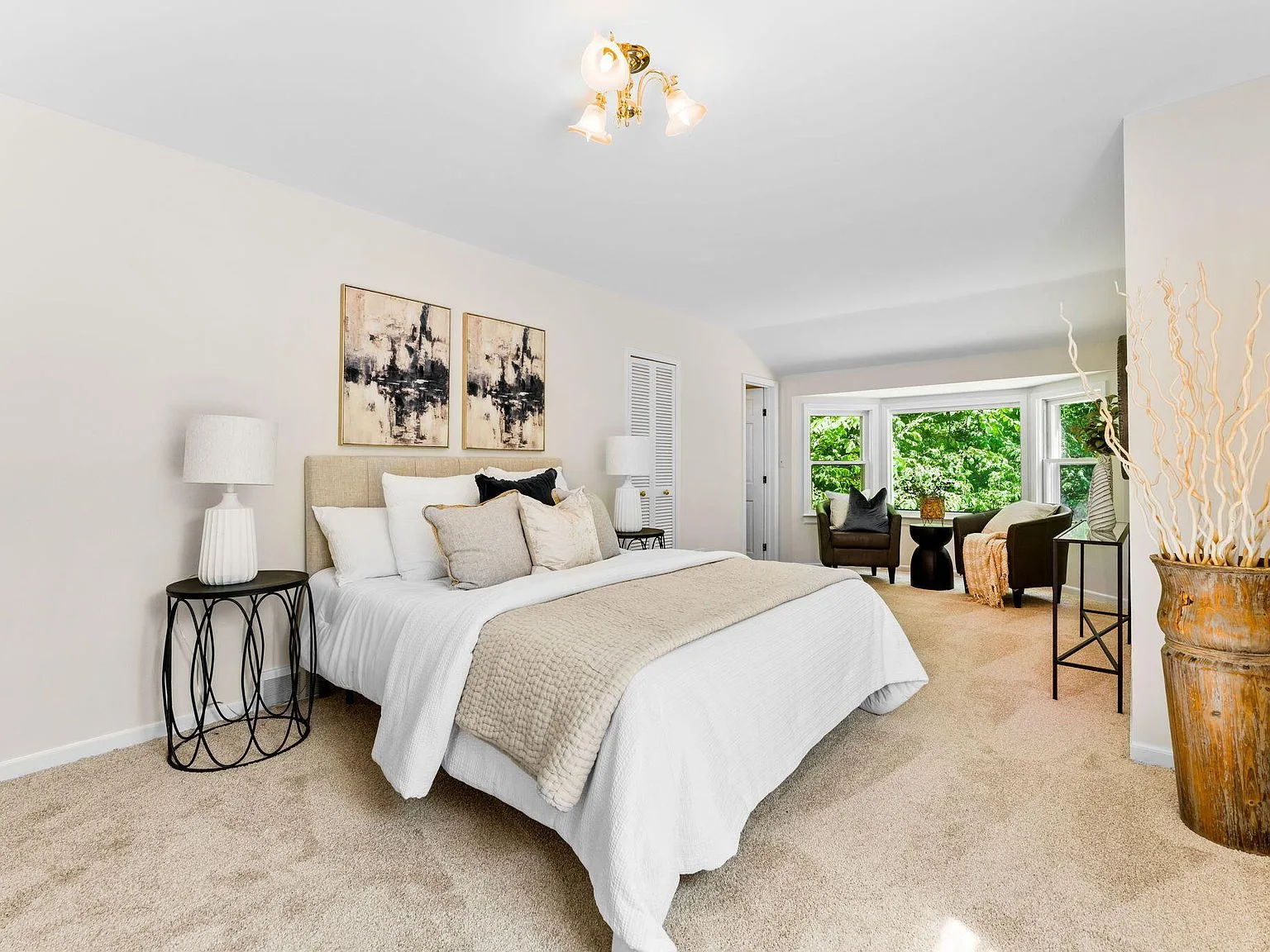 Master bedroom suite with bay window and neutral transitional decor