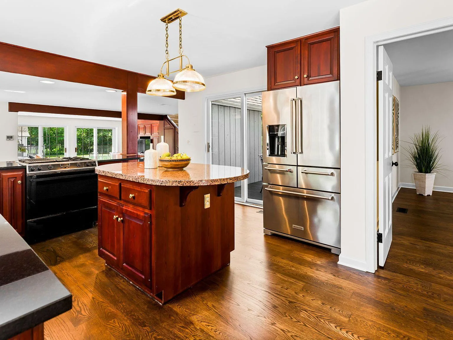 Kitchen with cherry cabinetry, granite countertops, and stainless steel appliances