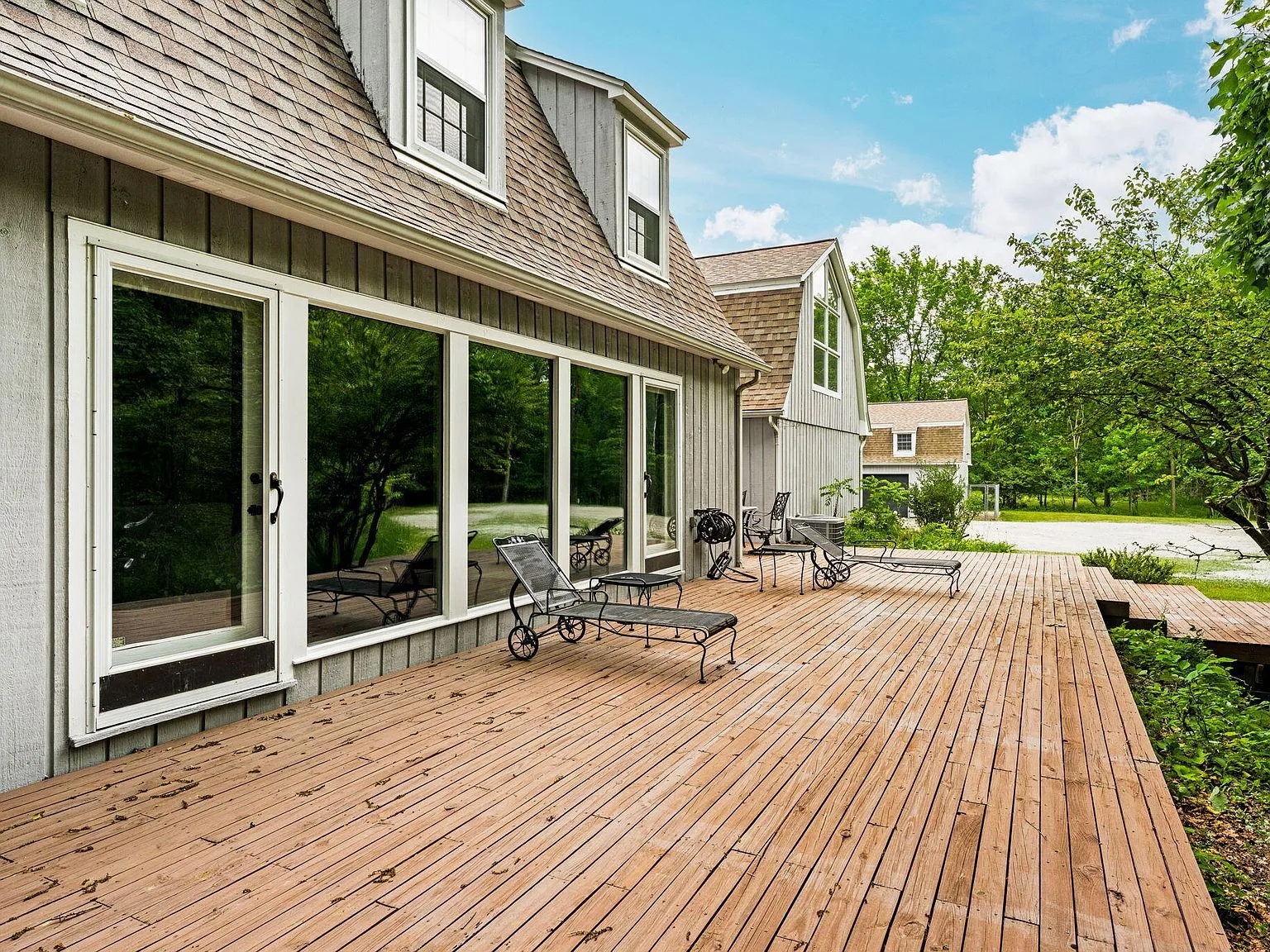 Expansive back deck with cedar-toned decking overlooking the tree canopy
