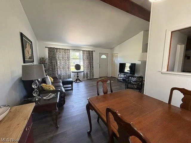 Spacious living room with vaulted ceiling and exposed beam