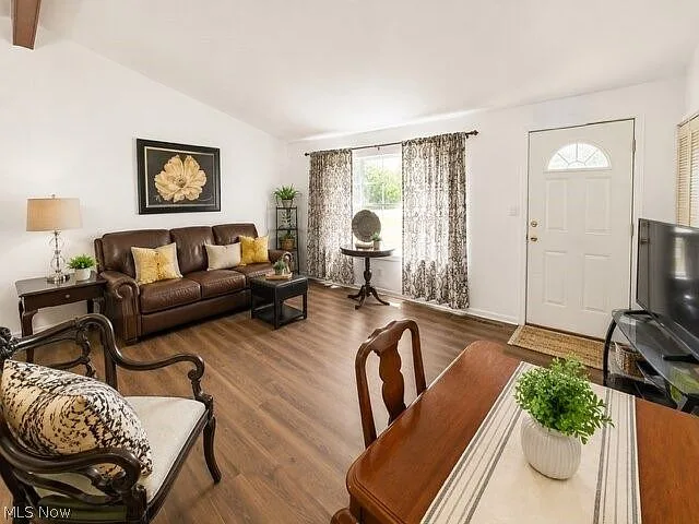 Open living and dining area with wood-look flooring