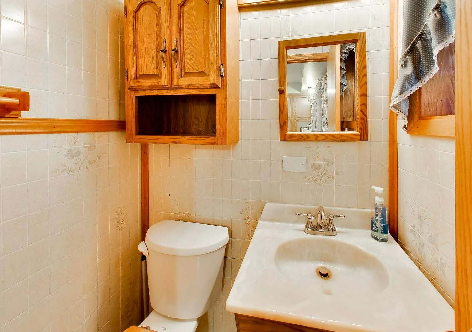 Traditional bathroom with white tiled walls and floral accents