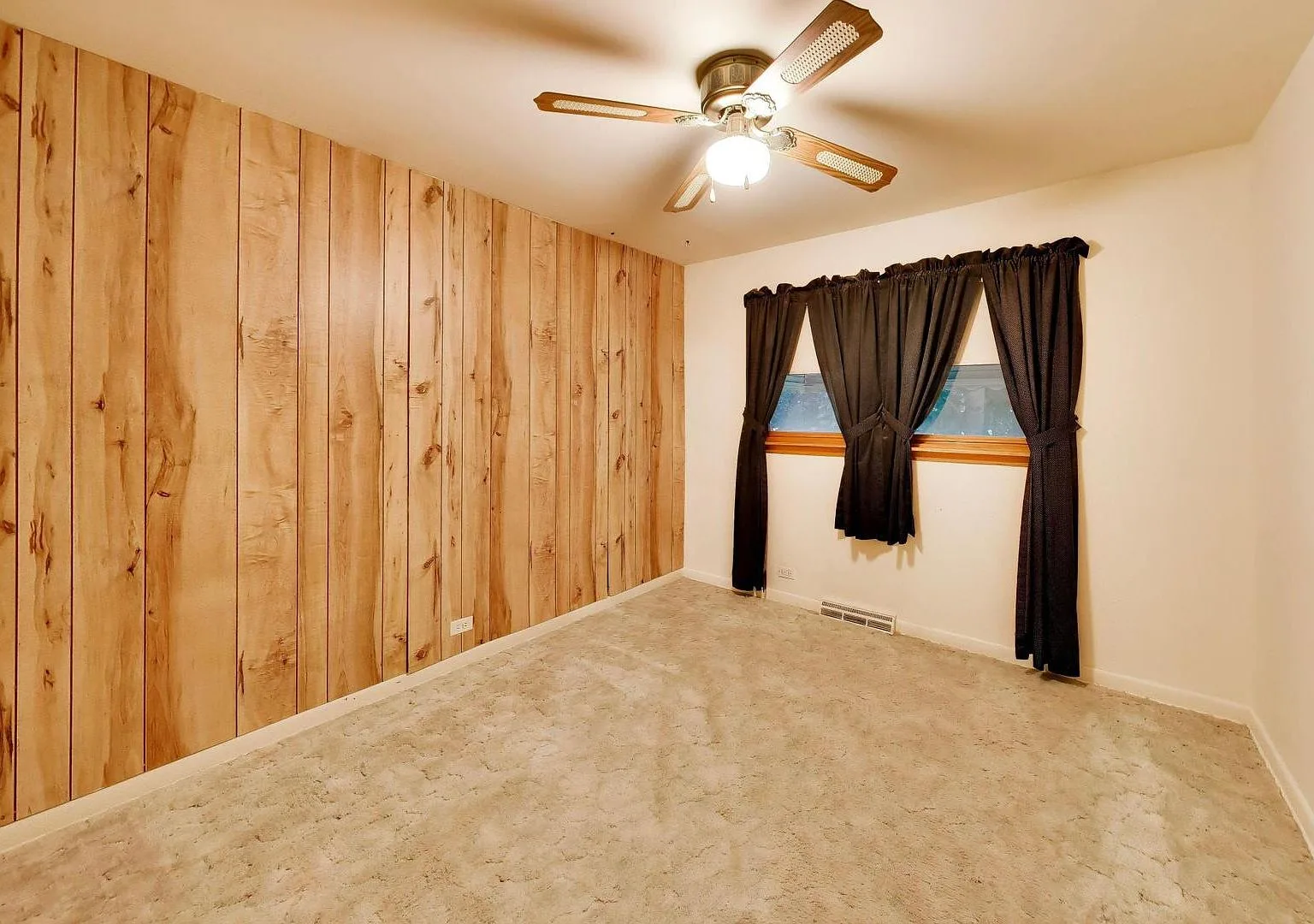 Bedroom with wood-paneled accent wall