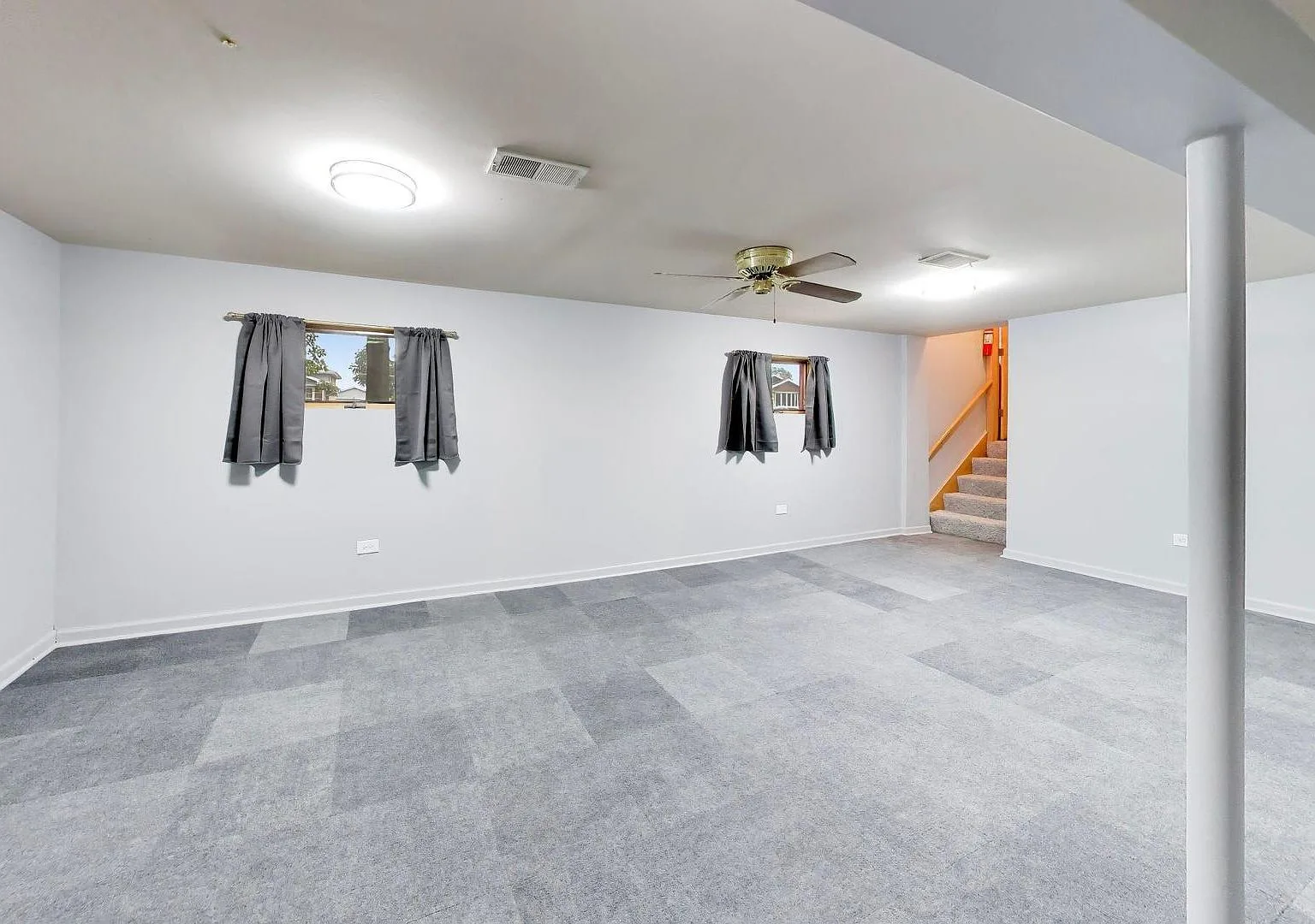 Lower-level recreation room with new carpet tiles