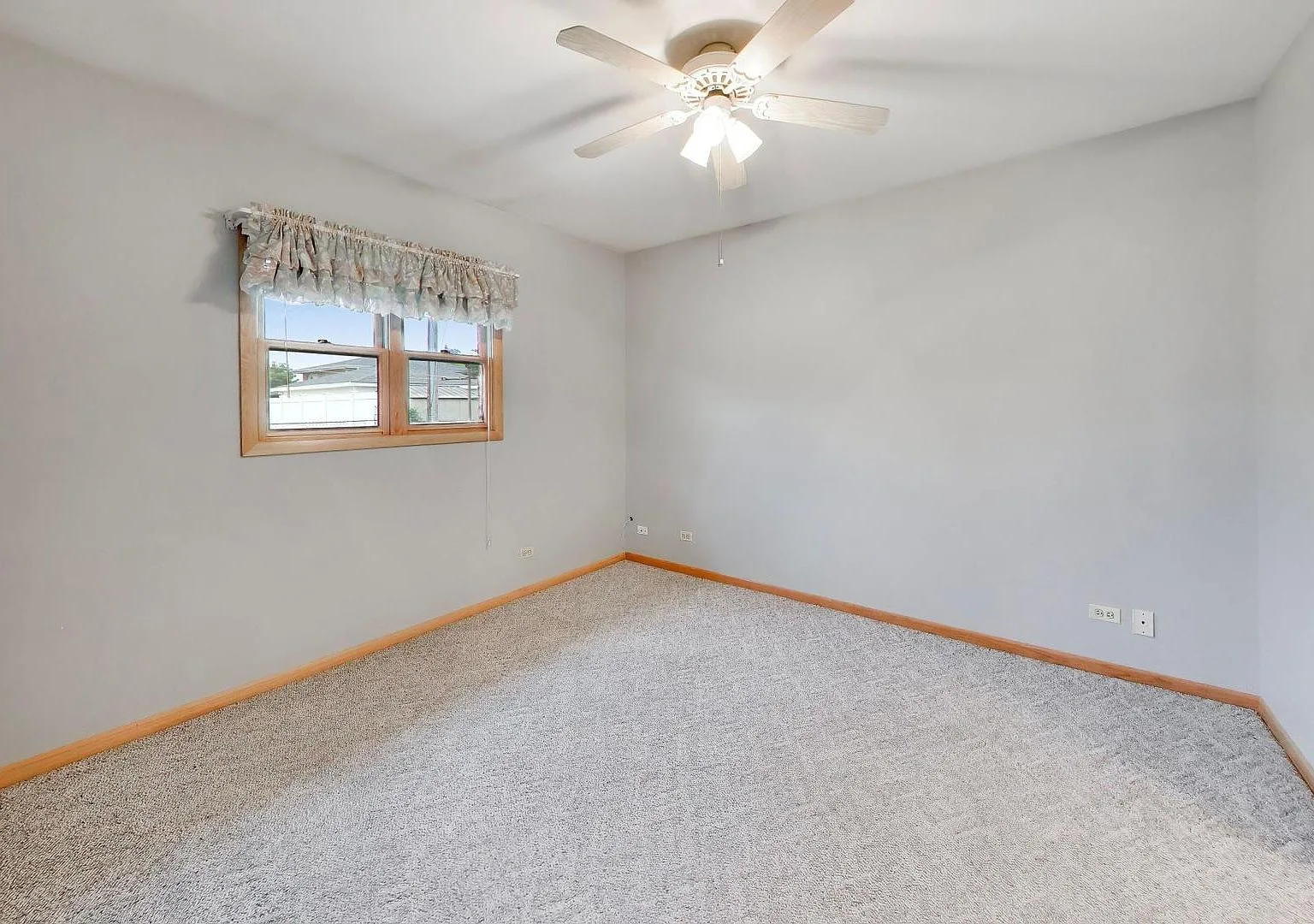 Neutral bedroom with gray walls and carpet
