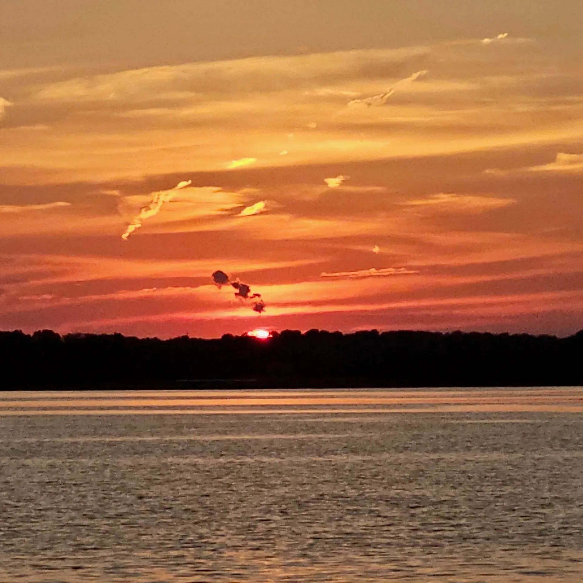 Sunset over Lake Hudson open water with warm colors reflecting on the calm surface